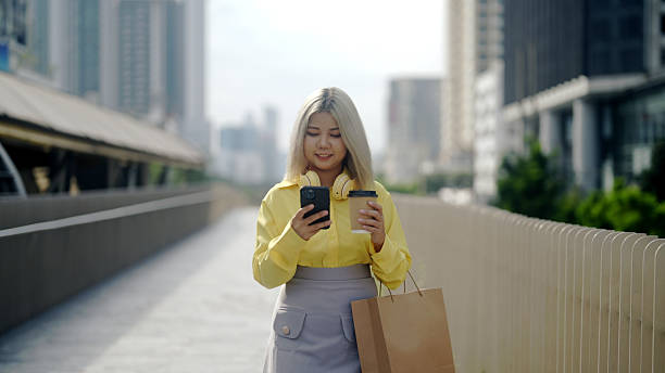istock A woman walks to work while on her cell phone. 2216200495