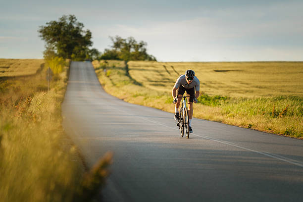 istock Professional cyclist sprinting on the road at sunset. 2216201765