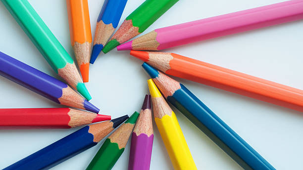 Colorful pencils arranged in a radial pattern on a white background. Perfect for themes like creativity, education, art, or back-to-school concepts.