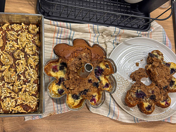 Preparing Gugelhupf and Homemade brown cocoa banana bread dessert with almonds and blueberries stock photo
