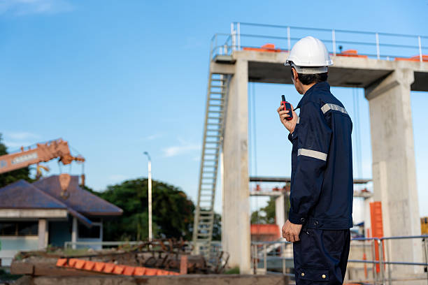 istock maintenance and inspector. Maintenance engineers are using walky talky to inform the results of inspection of buildings and structures. Irrigation engineers are exploring sluice systems 2216204970