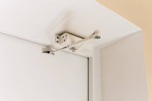 istock Door closer installed on a metal white door 2216205263