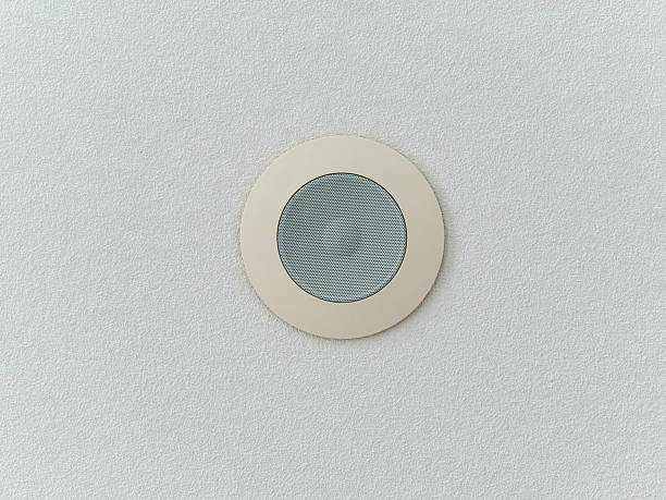 istock Bottom up view of in-ceiling speaker on white ceiling surface 2216205357