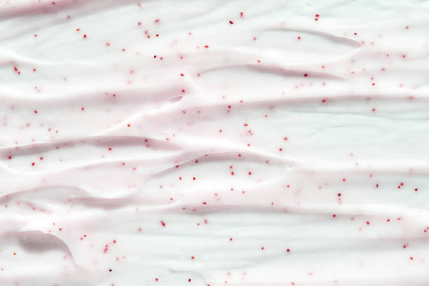 istock Smooth creamy texture with red speckles on white background 2216206478