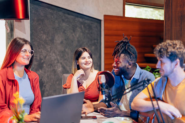 istock Radio hosts interviewing musician in recording studio podcast 2216206479