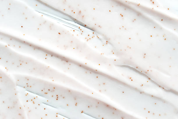 istock Smooth creamy texture with exfoliating particles on white background 2216206487