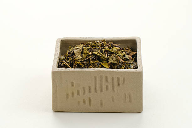 istock Dried tea leaves on bowl, copy space 2216206914