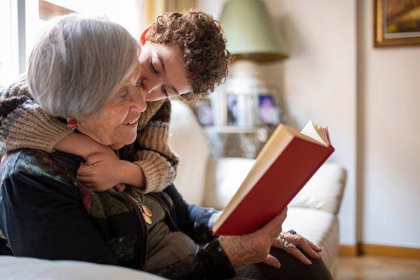 istock Grandchild embracing grandma while reading together 2216207509