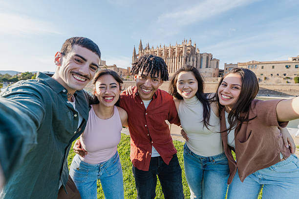 istock Young multicultural friends taking group selfie in Mallorca 2216210565
