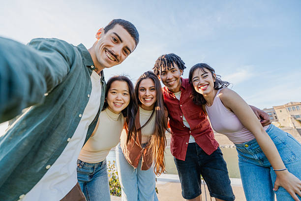 istock Happy multicultural friends posing for selfie 2216211103