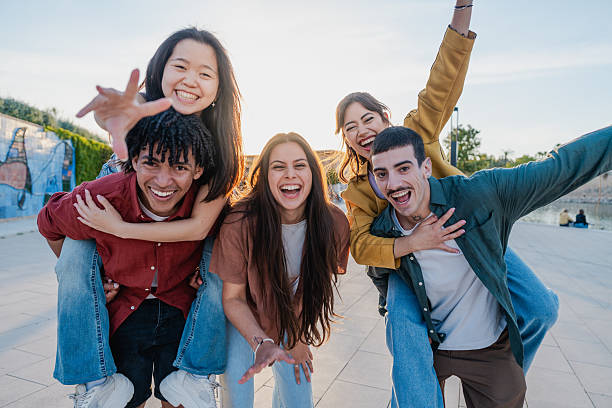 istock Cheerful diverse friends posing playfully at golden hour 2216211551