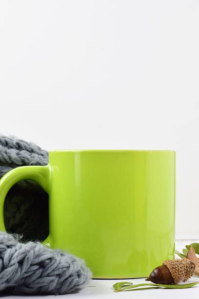 Vibrant coffee mugs stacked on a White minimalistic surface. Fun and Playful Color Cup Arrangement for Modern Product Display On white Background