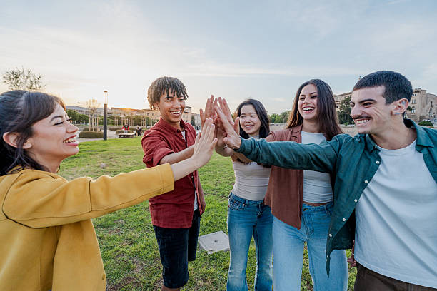 istock Diverse friends doing group high five outdoors 2216211952