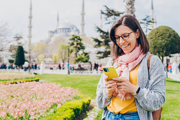 istock Cheerful woman using a mobile phone in Istanbul 2216212596