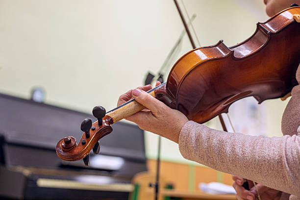 istock correct hand positioning when holding a bow and violin by a teacher 2216215259