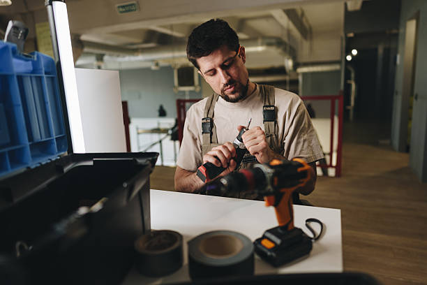 istock Craftsman prepares tools at a workbench in a modern workshop space during the day 2216216400