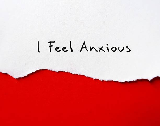 istock Torn paper on red background with text written I FEEL ANXIOUS - Feeling tense, restless or feeling nervous panicky and on-edge for no reason - Cope by accept uncertainty and relieve anxiety 2216217174