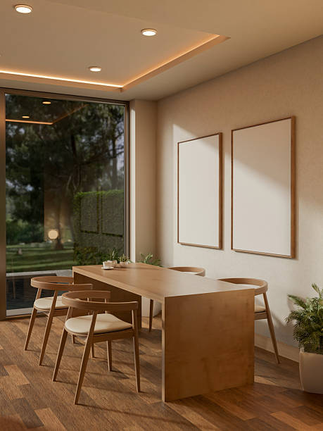 A coffee cup on wooden counter and armchairs in a cafe with blank frames hanging on the wall