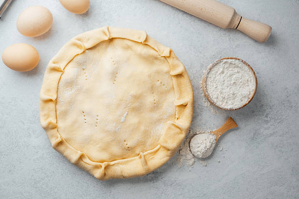 istock Baking homemade pie crust with fresh ingredients on a countertop 2216217530