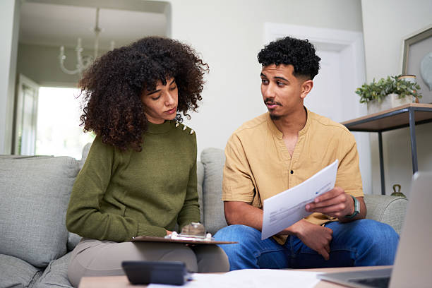 istock Couple Discussing Financial Documents Together in Modern Home Interior Setting 2216221451