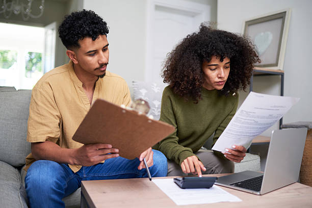 istock Focused Couple Collaborating on Financial Planning at Home with Documents and a Laptop 2216221496