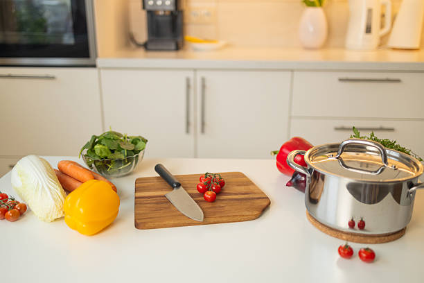 istock Chopping cherry tomatoes on a wooden cutting board in the kitchen 2216221507
