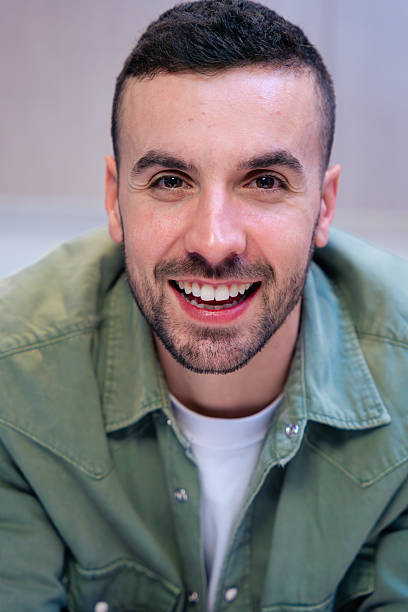istock Portrait Young man smiling and looking at camera in modern kitchen interior. 2216221593