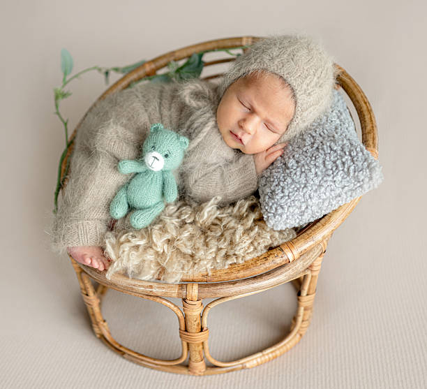 istock Newborn Baby Is Sleeping With A Smile 2216224432