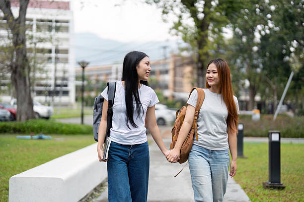 istock Friendship and Walk. Two students walking hand-in-hand on campus while reflecting on their classes and future aspirations. 2216226139