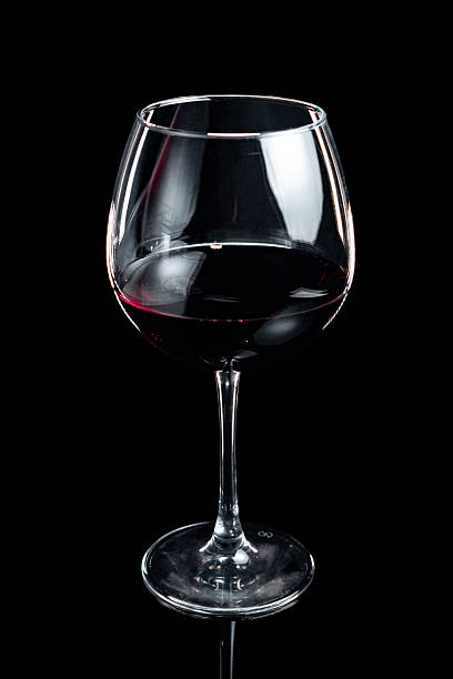 istock The glass of red wine on a black background 2216228253