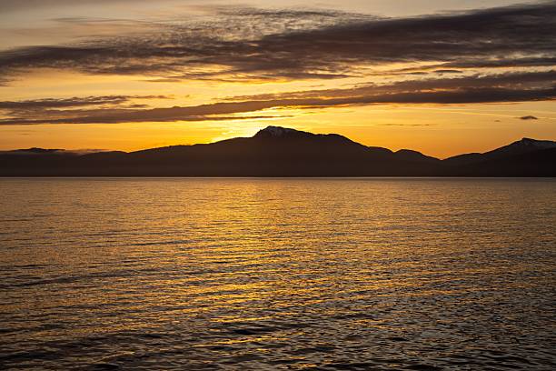 istock Serene sunset over sea and mountains. 2216228787