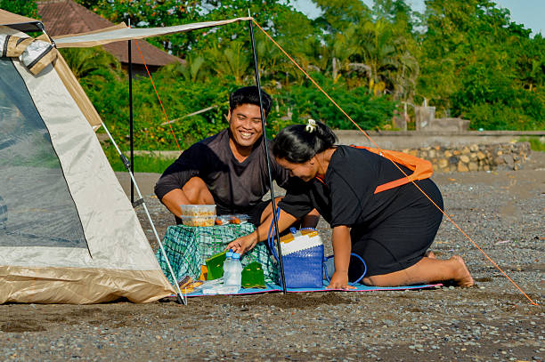 istock Parents laughing joyfully while arranging lunch by the tent 2216229784