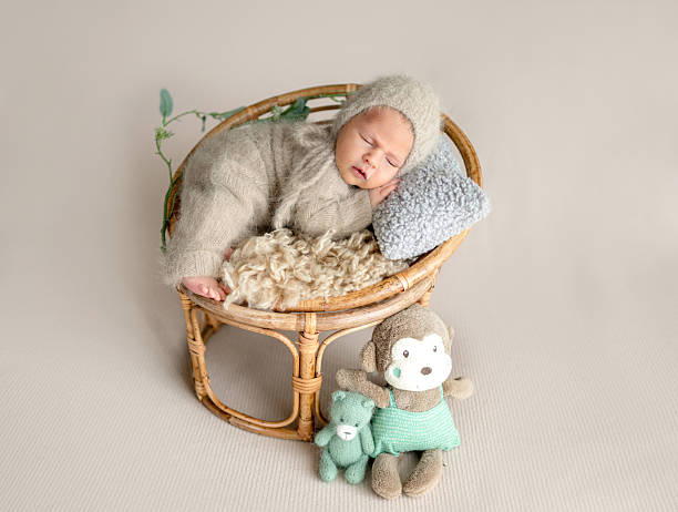 istock Newborn Baby Is Sleeping With A Smile 2216230023