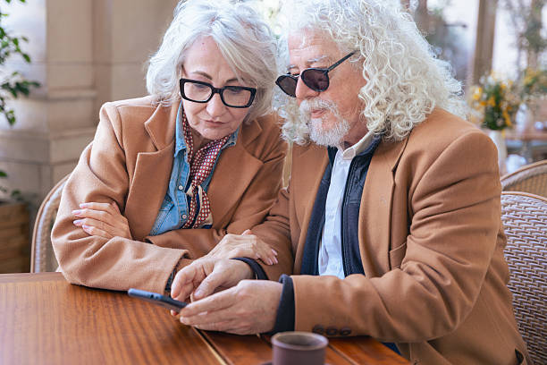 istock Happy senior couple using smartphone together, smiling and enjoying technology. 2216230368