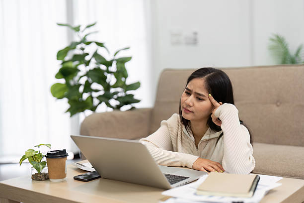 istock Working from Home and Focused Thought. A woman contemplating her laptop screen while working from home, reflecting on her tasks and responsibilities. 2216230588