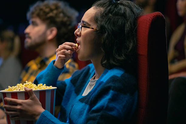istock Hispanic Couple Enjoying Popcorn in Cozy Modern Cinema Setting 2216230779