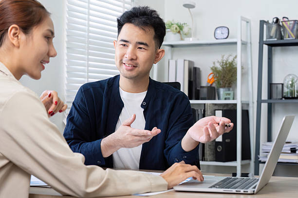 istock Collaboration and Communication. Two colleagues discussing project details in a modern office setting. 2216231762