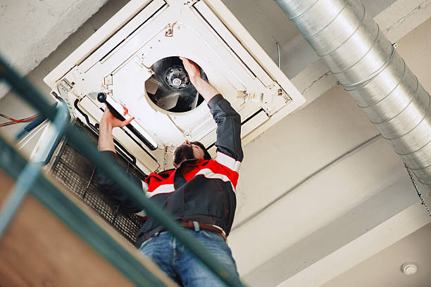 istock Technician repairs ventilation system in commercial building during daylight hours 2216233609