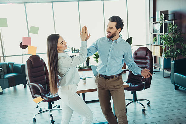 istock Confident coworkers celebrating teamwork in a collaborative office environment filled with motivation and success 2216233631