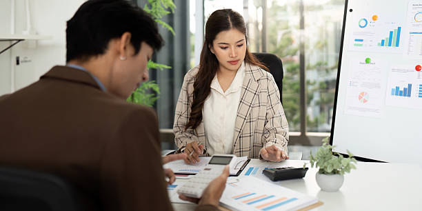 istock Collaborative Financial Planning. Professionals analyzing budget reports in a modern office. 2216234652