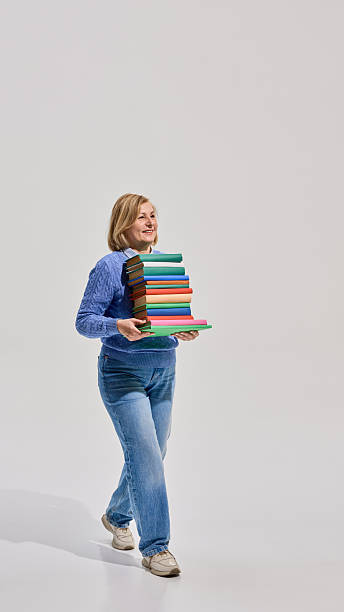 istock Woman reading book with legs up 2216235006