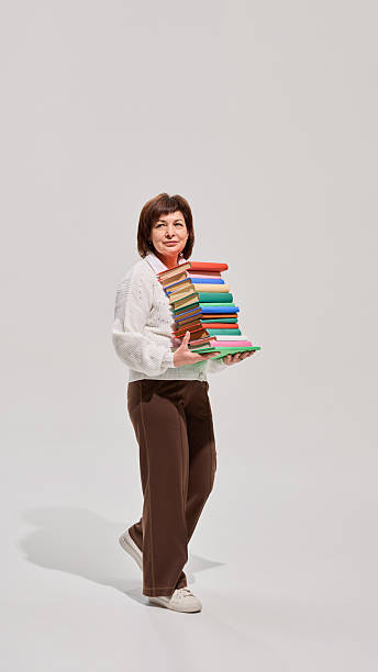 istock Senior woman holding book above head 2216235007