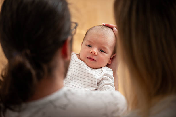 istock Parents Gently Cradling Their Newborn Baby 2216236873