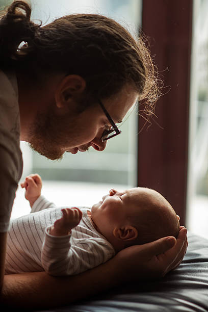 istock Tender Moment Between Father and Newborn Baby 2216237576