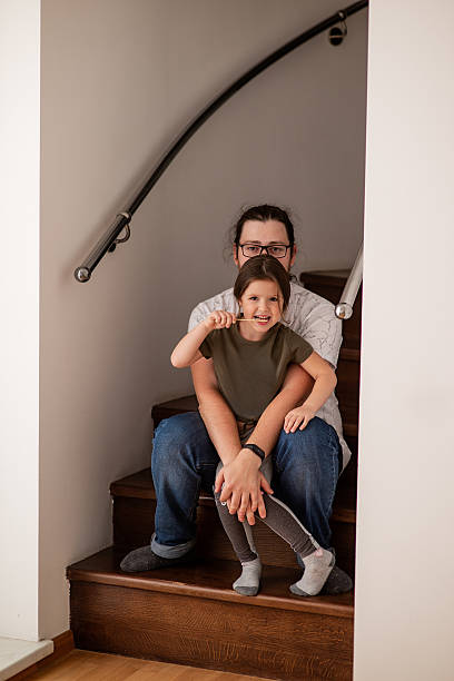 istock Father and Daughter Bonding on Staircase at Home 2216237625
