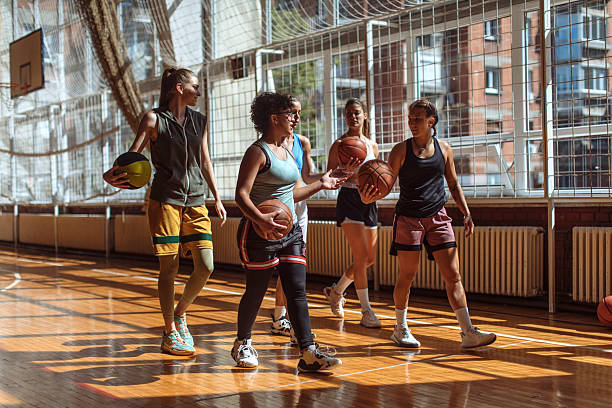 istock Female Basketball Team Practicing on Indoor Court 2216237920