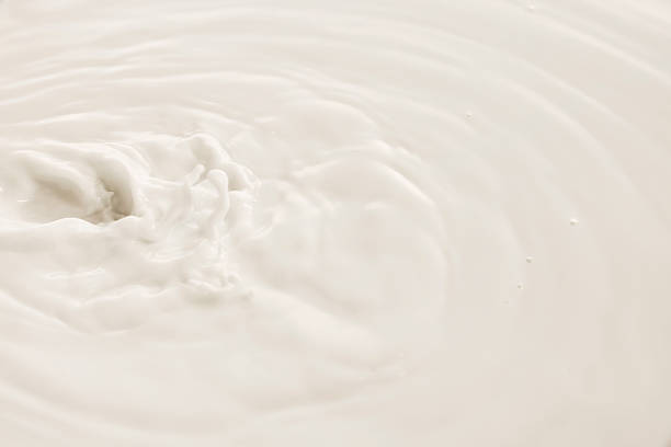 istock White milk swirls in soft circular motion with textured surface and natural flow. 2216240182