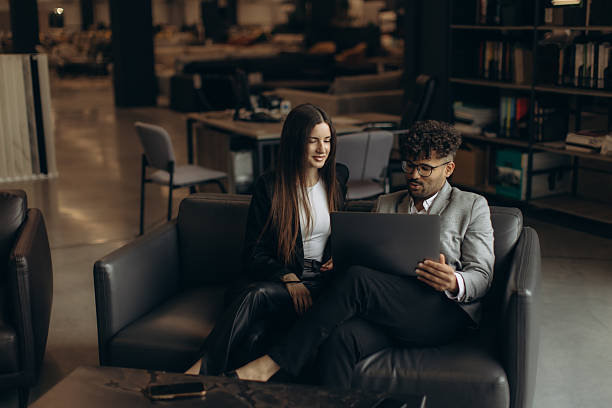 istock Business Professionals Collaborating on a Laptop in a Modern Office Setting 2216241124