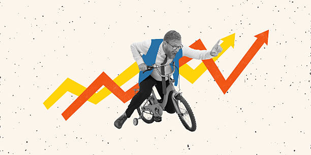 istock Second Wind. Conceptual art collage. Businessman aggressively pedals small bike while yelling, arrows showing fierce competitive ambition. 2216241555