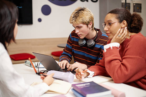 istock Teenage Boy Studying with Friends 2216242330